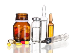 IM vitamin injection ampoules, syringe, and supplement pills for wellness support